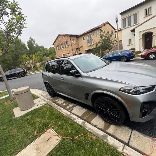 Silver SUV parked on residential street with other vehicles nearby